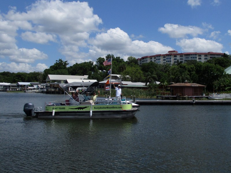 Customers waving as they return from a boat tour